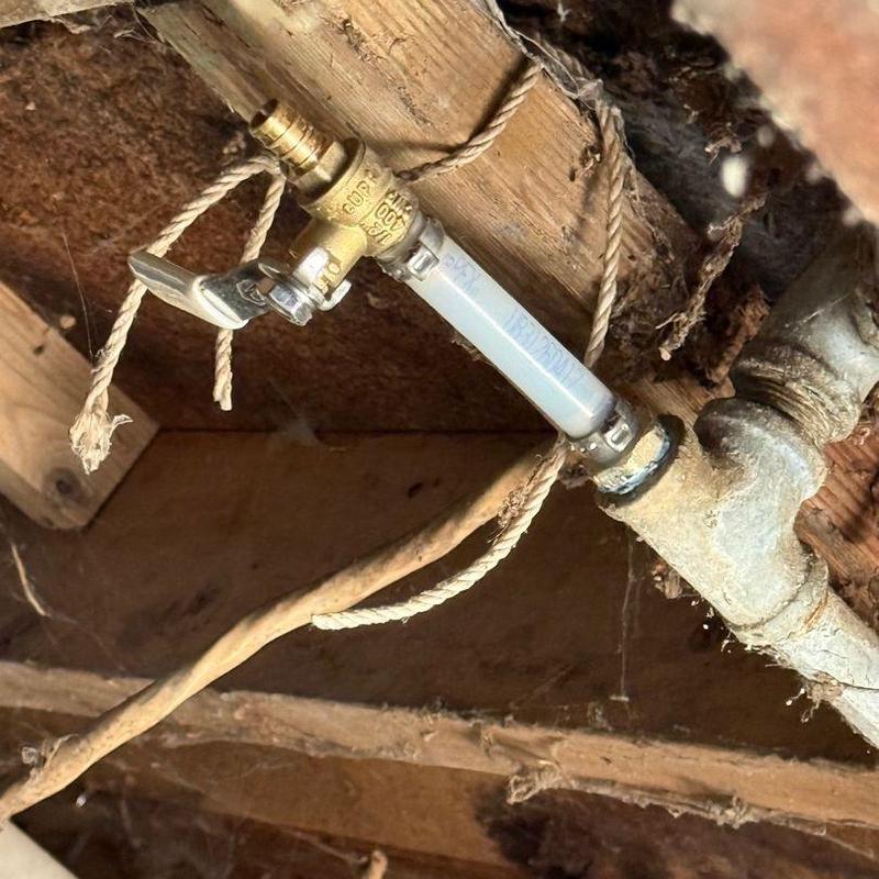 PEX water pipe with shutoff valve installed under floor