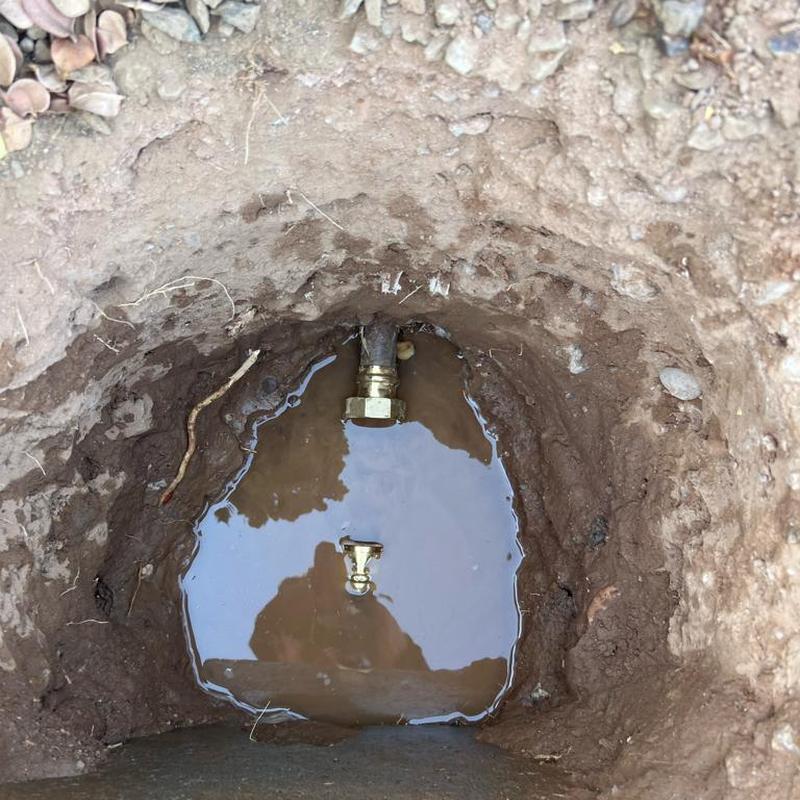 1-inch pressure regulator valve in muddy excavation hole