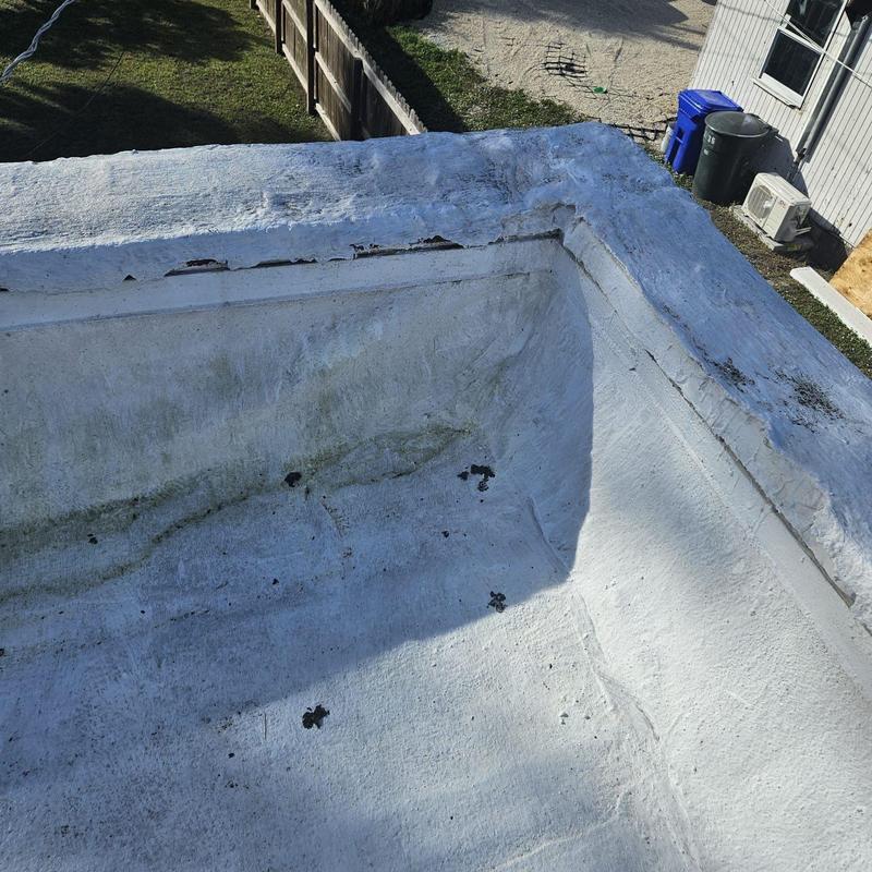 Flat roof with cracks and water damage