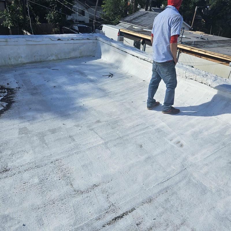 Flat roof surface with standing water and poor pitch