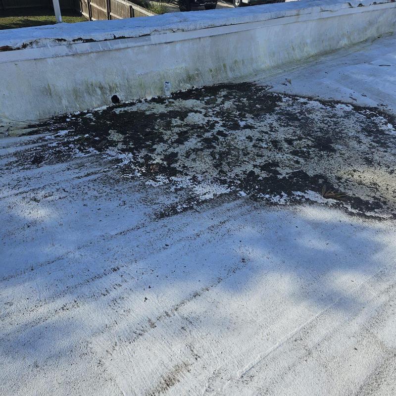 Flat roof with active leaks and water damage