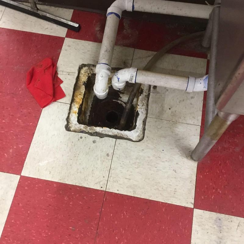Floor sink drain with connected PVC pipes in kitchen Floor sink drain with connected PVC pipes in kitchen