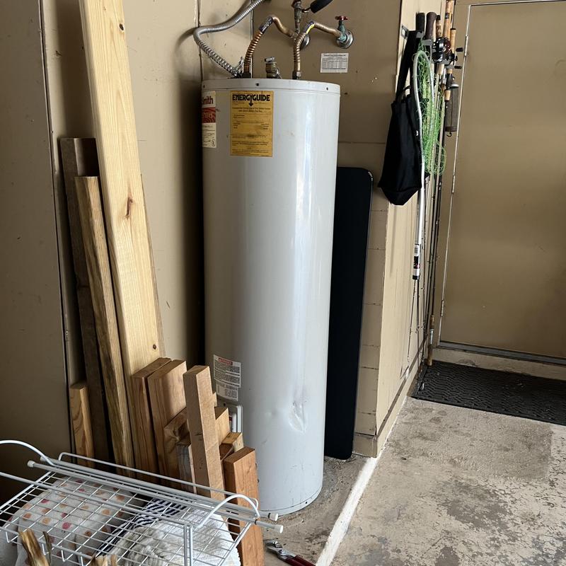Water heater with piping and vent in garage Water heater with piping and vent in garage