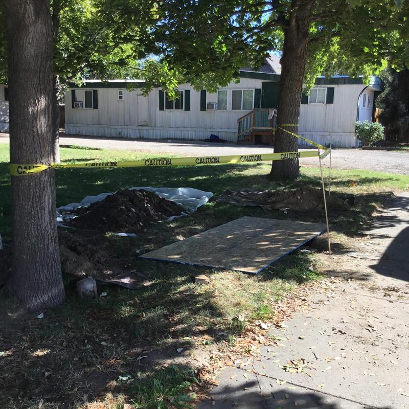 Water meter leak excavation with caution tape Water meter leak excavation with caution tape