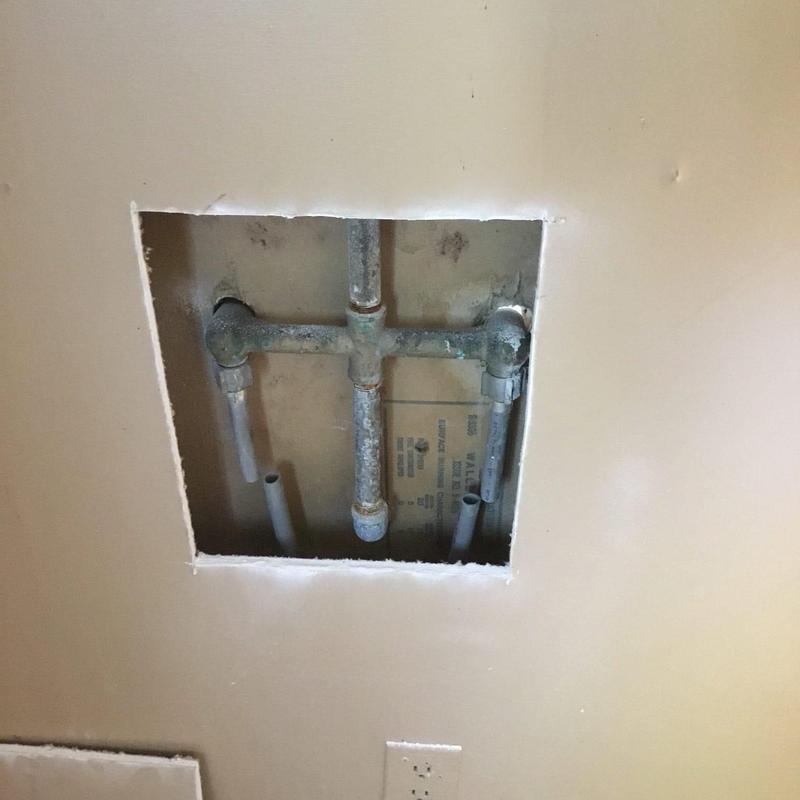 Two-handle tub shower valve plumbing access cutout Two-handle tub shower valve plumbing access cutout