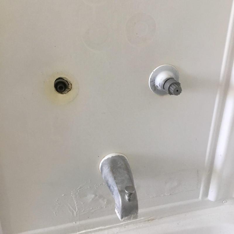 Two-handle tub shower valve with missing handle and spout Two-handle tub shower valve with missing handle and spout
