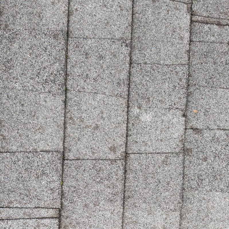 Asphalt shingle roof surface with weathering marks Asphalt shingle roof surface with weathering marks