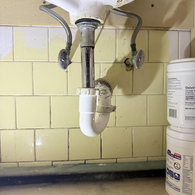 Sink drain pipe and emergency shutoff valves under vanity