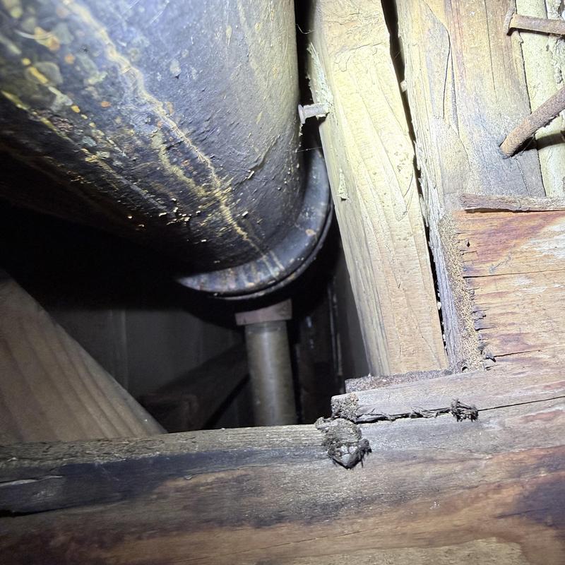 Drain pipe inside wooden wall cavity near vanity area