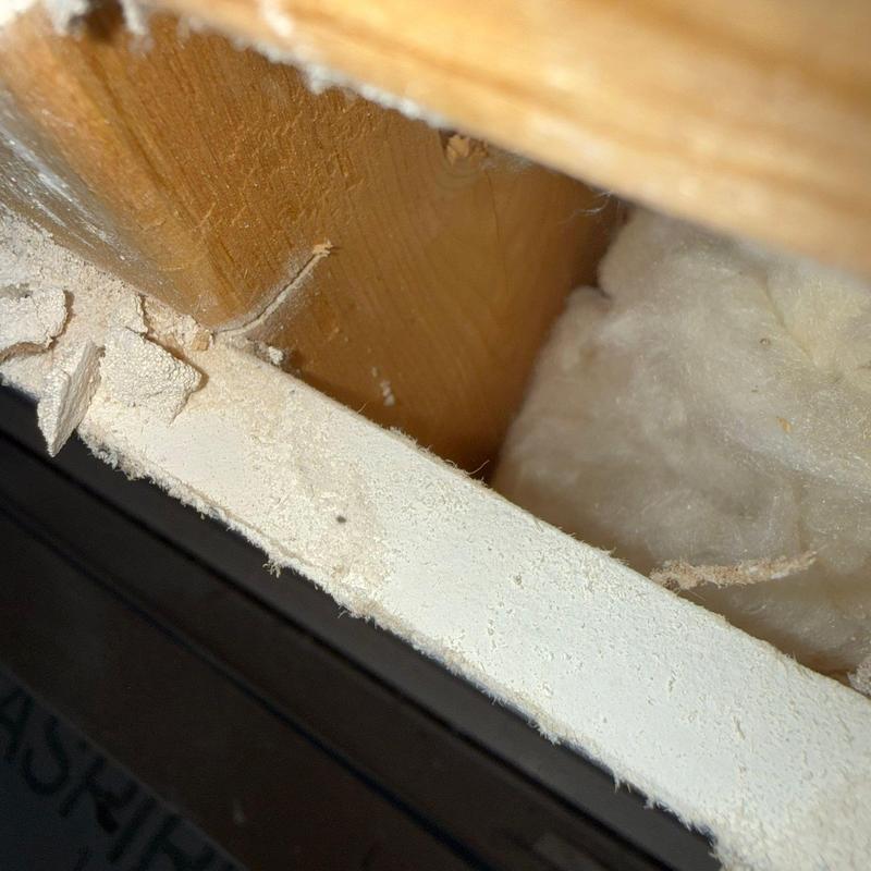 Drywall edge and attic insulation close-up view