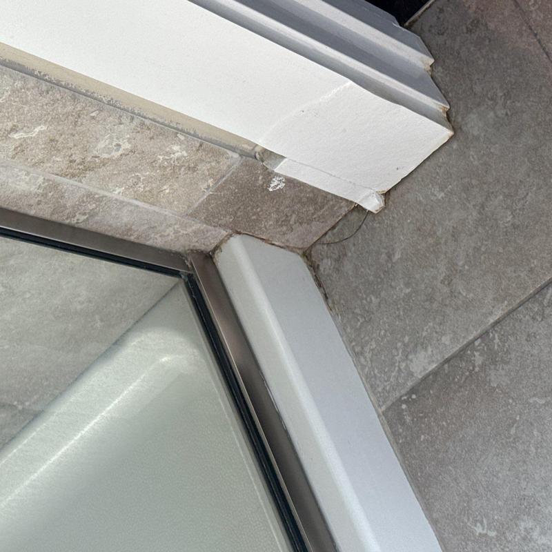 Window frame corner with wall and tile interface