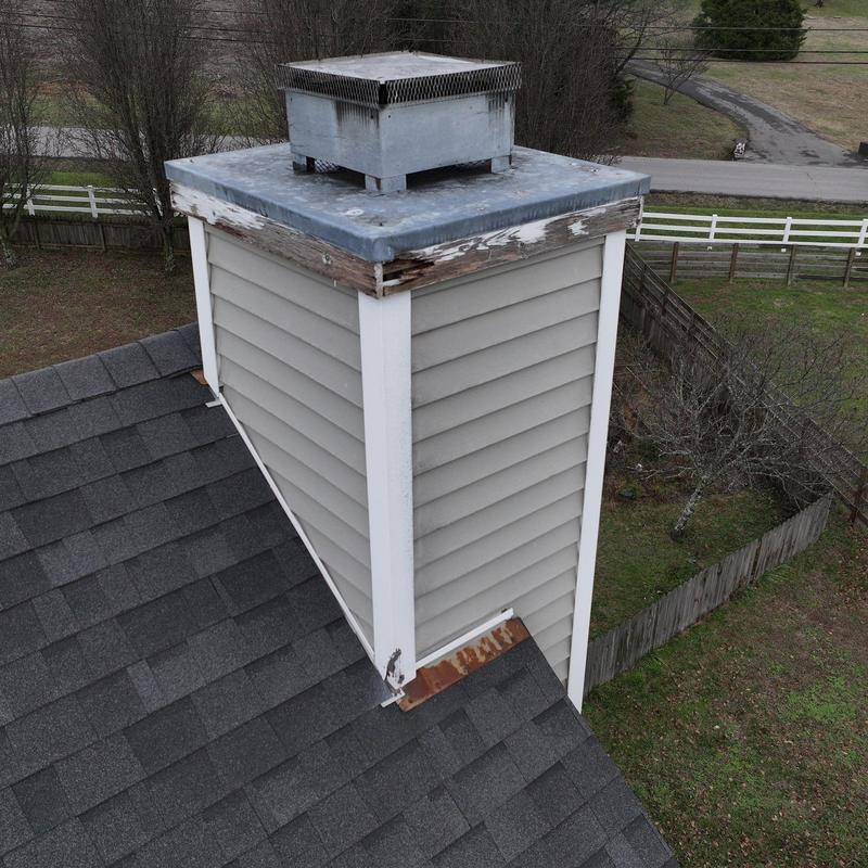 Chimney siding and roof shingle inspection with damage