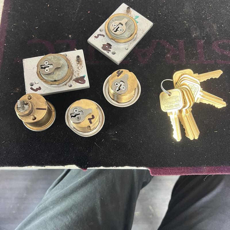 Cylinder locks with new keys on black mat surface