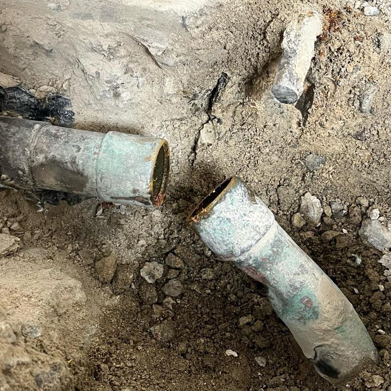 Copper water line exposed and cut for repair