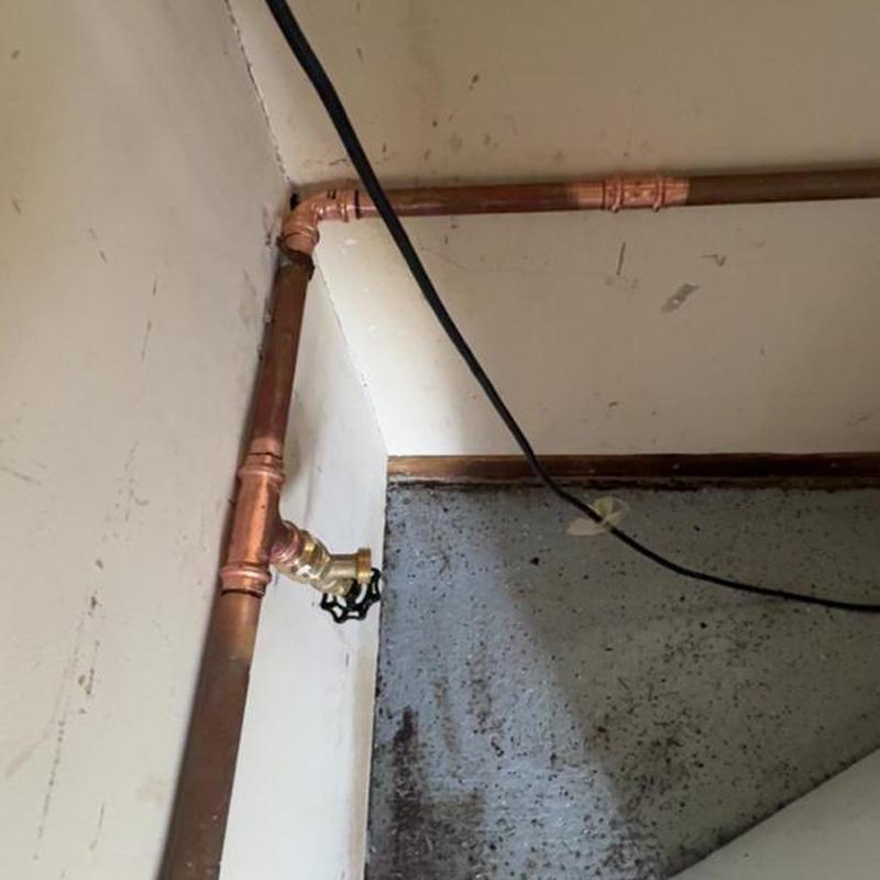 Copper pipe with outdoor spigot in corner wall