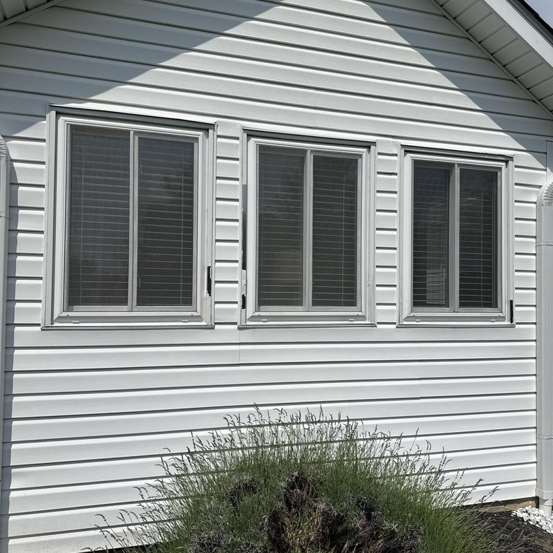 Window fascia and trim on white siding exterior