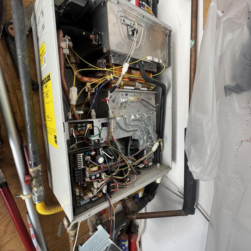 Tankless water heater gas component cleaning in wall Tankless water heater gas component cleaning in wall