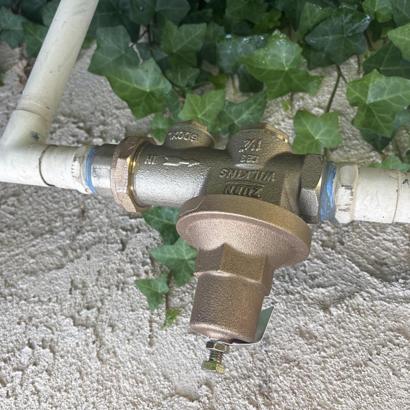 Brass pressure regulator valve on outdoor water line Brass pressure regulator valve on outdoor water line