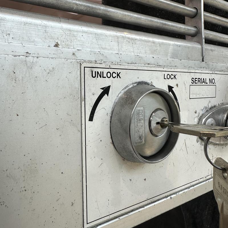 Gate lock cylinder with inserted key at store gate