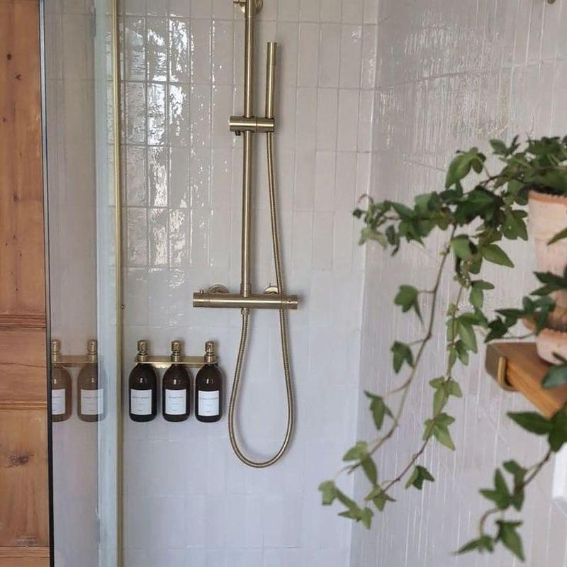 Tub stop adjustment with gold shower fixture Tub stop adjustment with gold shower fixture