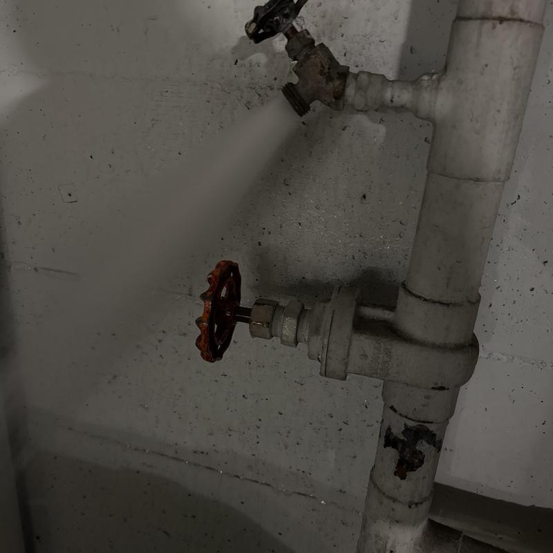 Water pipe valve leaking with spray from open valve