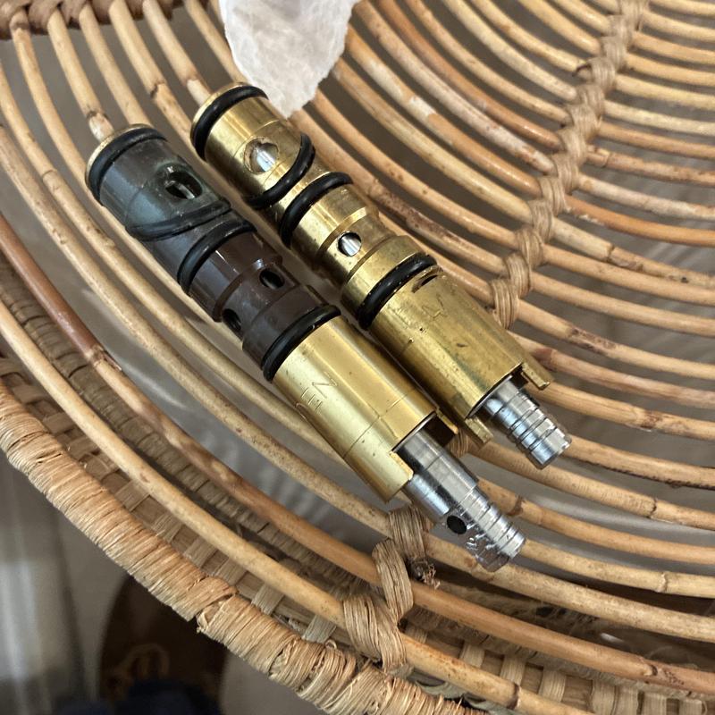 Moen shower faucet cartridges with O-rings on rattan surface