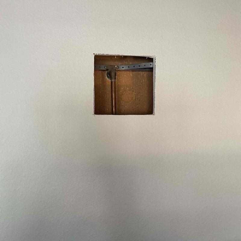 Copper shower pipe inside drywall opening in master bathroom Copper shower pipe inside drywall opening in master bathroom