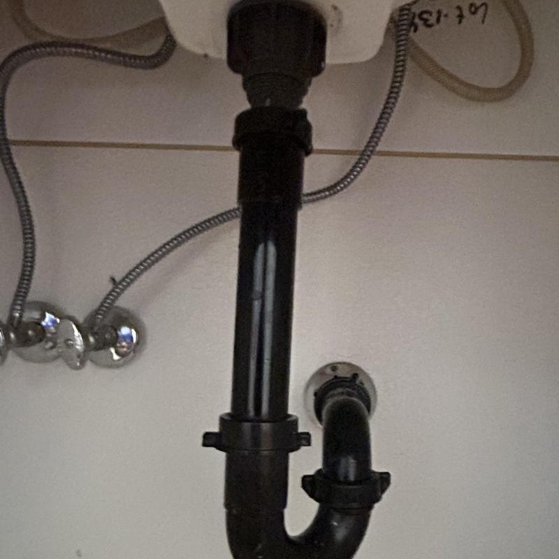 Pop-up drain assembly and P-trap plumbing under sink