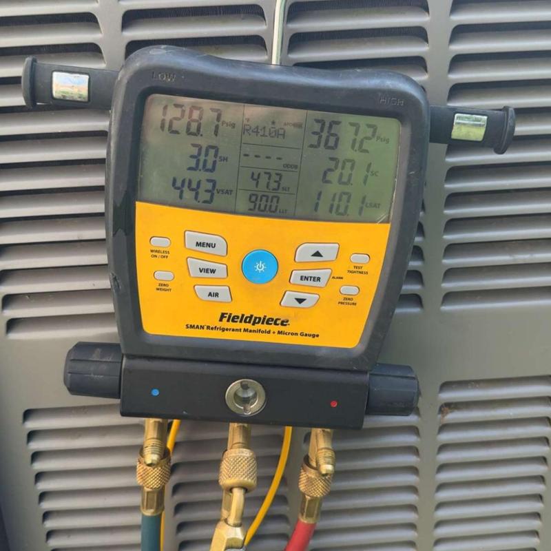 Refrigerant manifold gauge measuring AC unit pressures Refrigerant manifold gauge measuring AC unit pressures