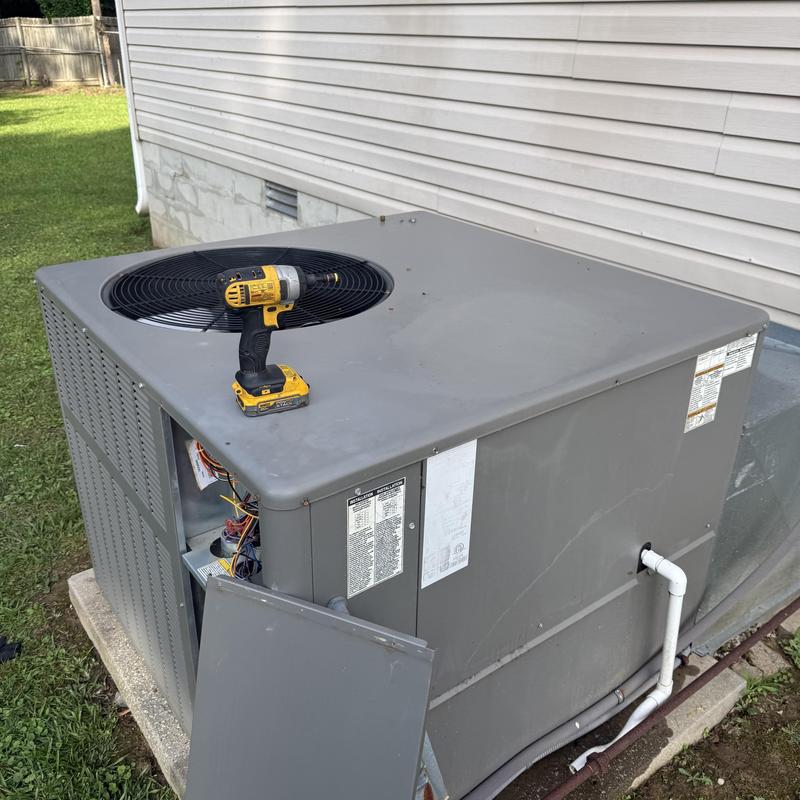 HVAC outdoor unit with opened panel and drill on top HVAC outdoor unit with opened panel and drill on top