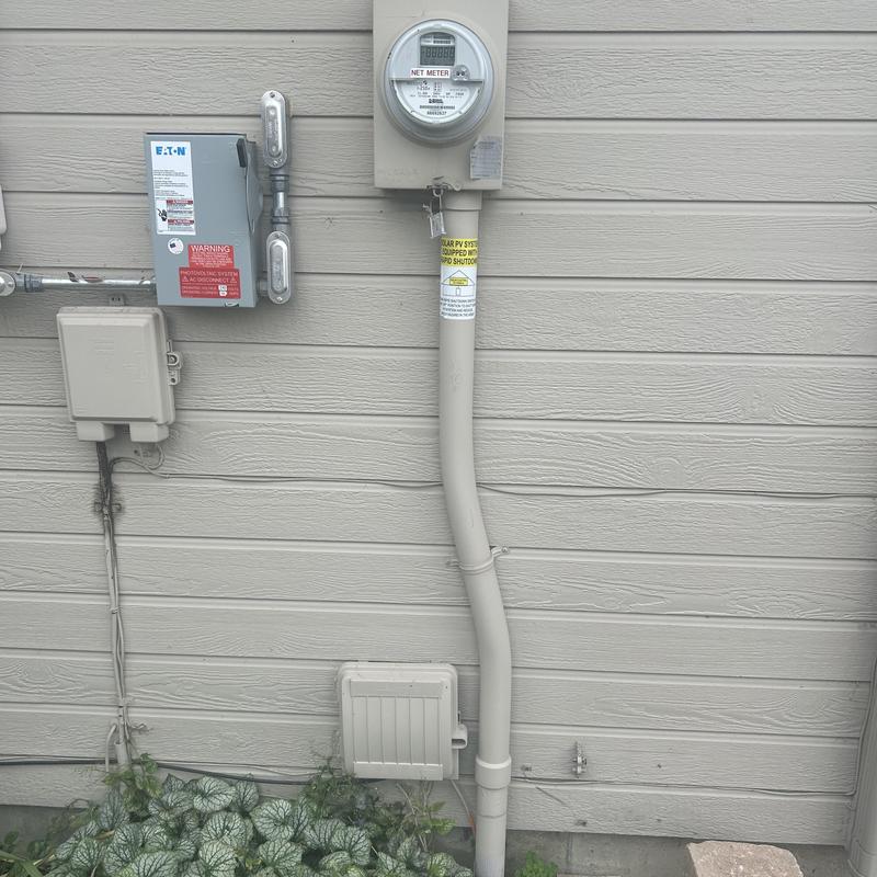 Electric meter and circuit breaker box on exterior wall Electric meter and circuit breaker box on exterior wall