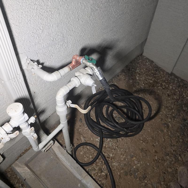 Water service bypass with temporary hose line outdoors Water service bypass with temporary hose line outdoors