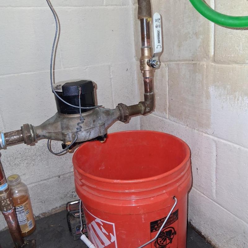 Water meter valve and copper elbow installation with bucket