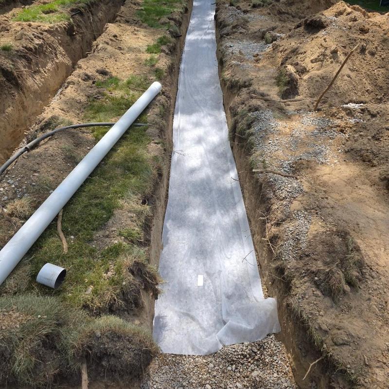Septic field trench with pipe installation materials