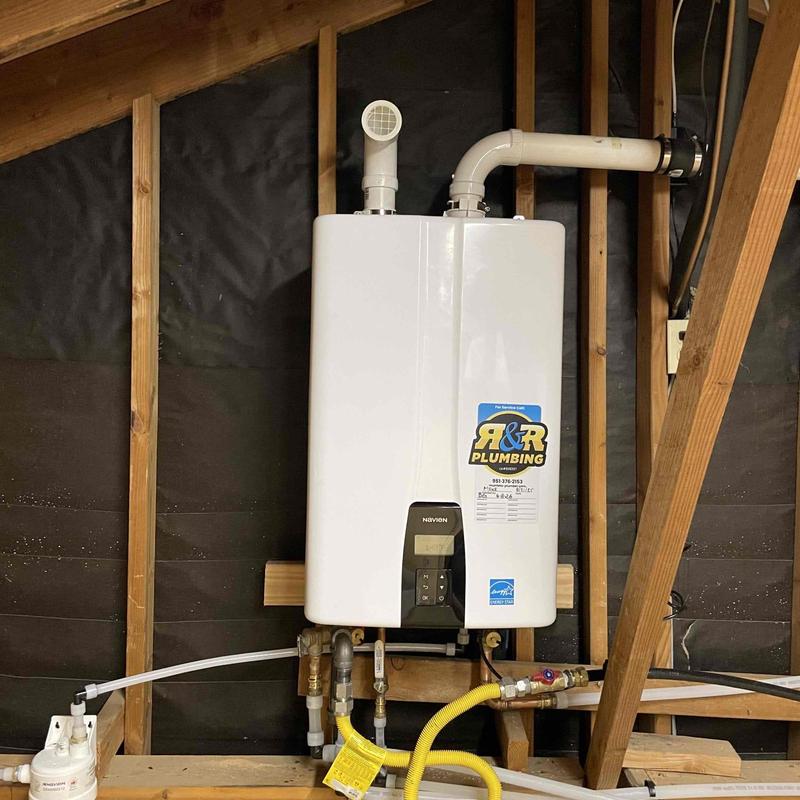 Tankless water heater with vent and plumbing connections Tankless water heater with vent and plumbing connections