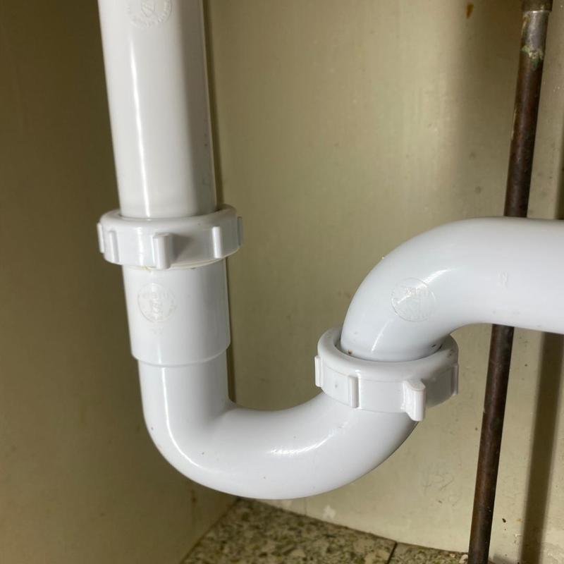 PVC plumbing trap with replaced tubular fittings