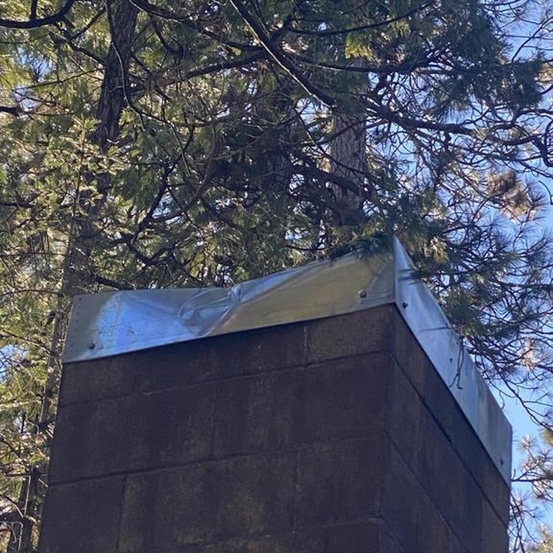 Metal chimney flashing with dented corner repair