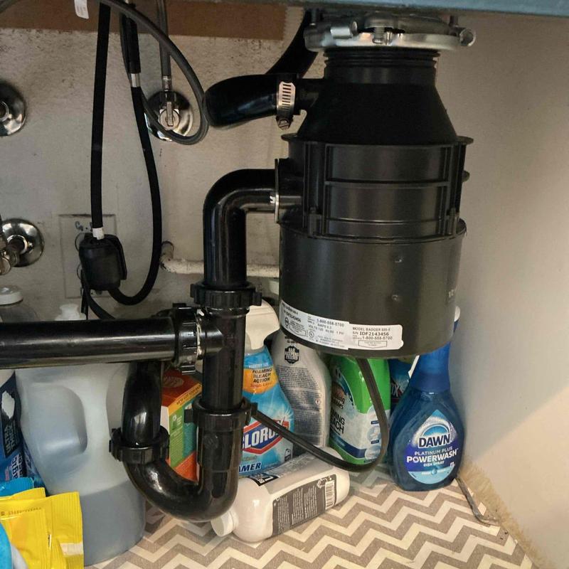 Garbage disposal unit with connected plumbing pipes Garbage disposal unit with connected plumbing pipes