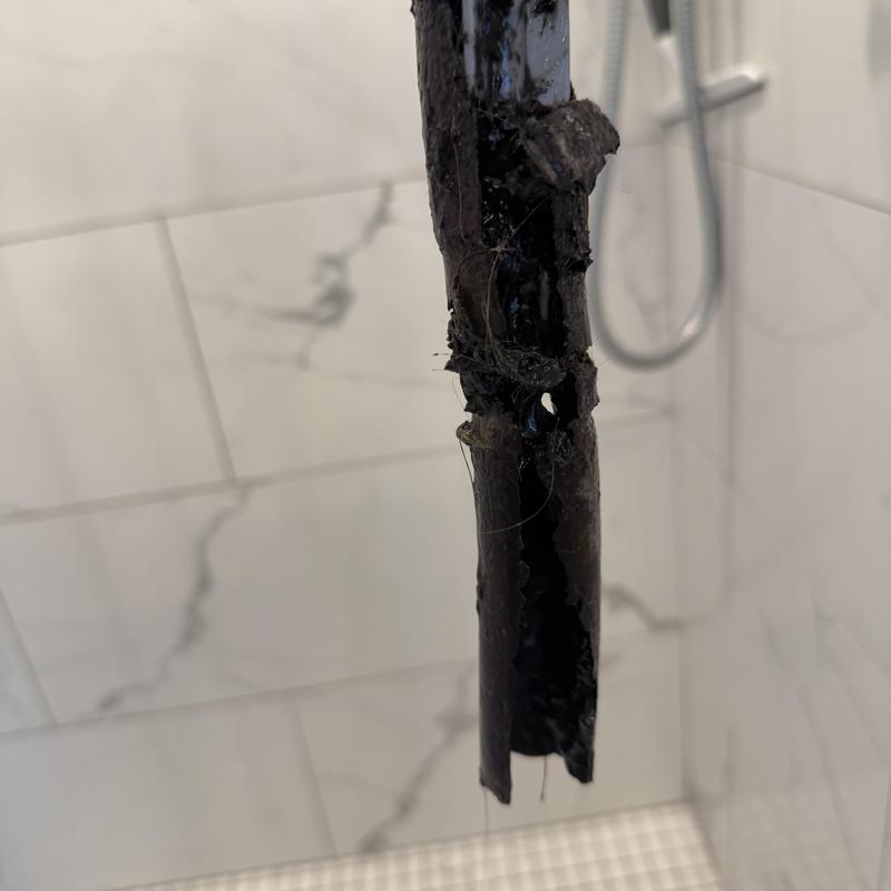 Bathroom drain pipe with corrosion and damage Bathroom drain pipe with corrosion and damage