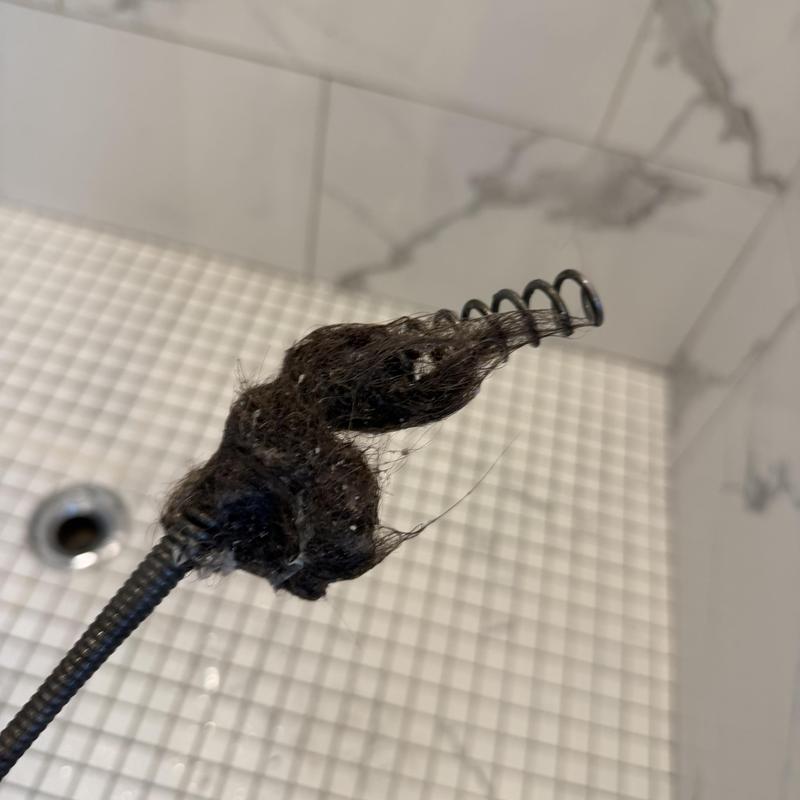 Shower drain clog with hair removed by auger tool Shower drain clog with hair removed by auger tool