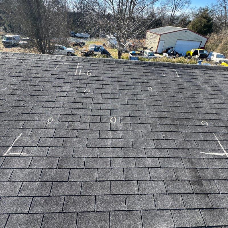 Roof shingles with hail damage marked in chalk
