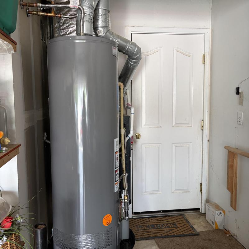 Water heater installation with vent piping in residential room Water heater installation with vent piping in residential room