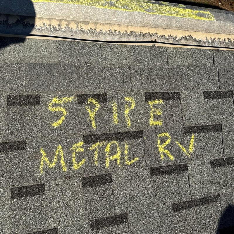 Roof shingles with hail damage markings in yellow