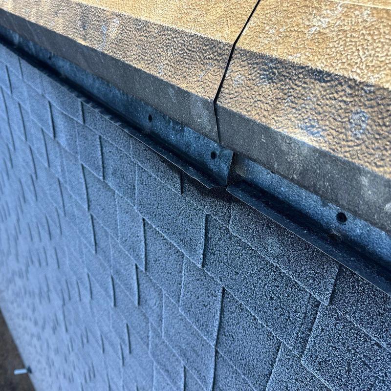 Metal drip edge on asphalt shingle roof edge with gaps