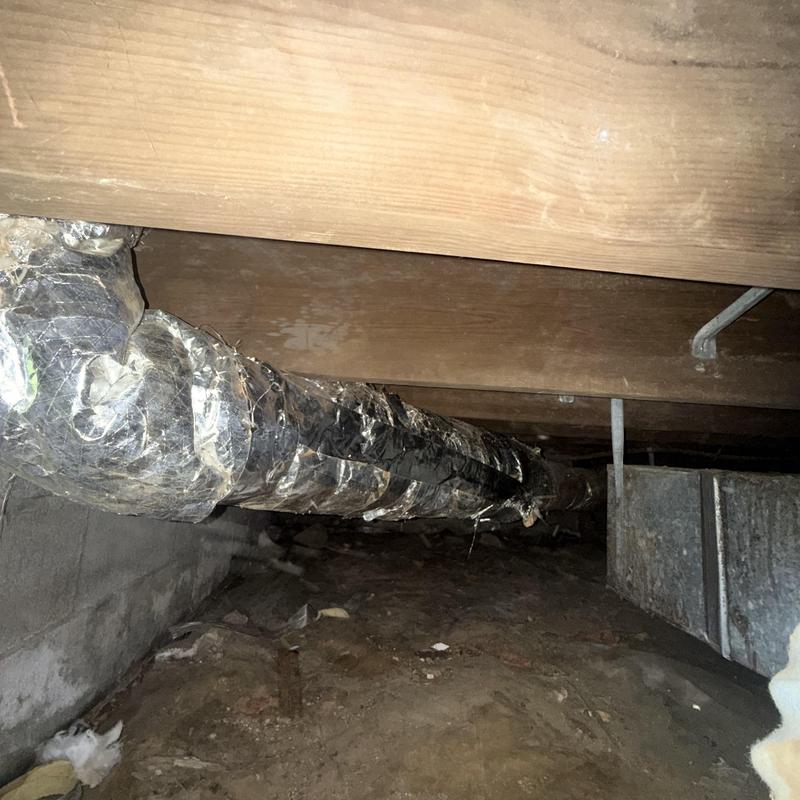 Insulated HVAC air ducts hung under house crawlspace Insulated HVAC air ducts hung under house crawlspace