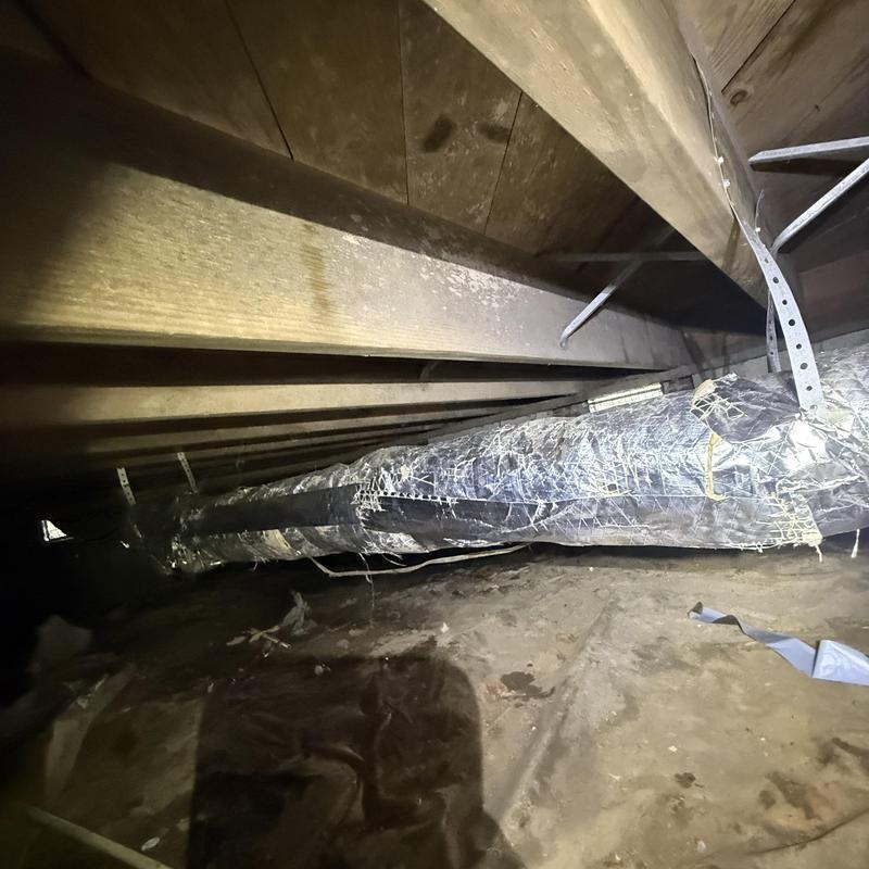 Underhouse insulated air duct secured with metal hangers Underhouse insulated air duct secured with metal hangers