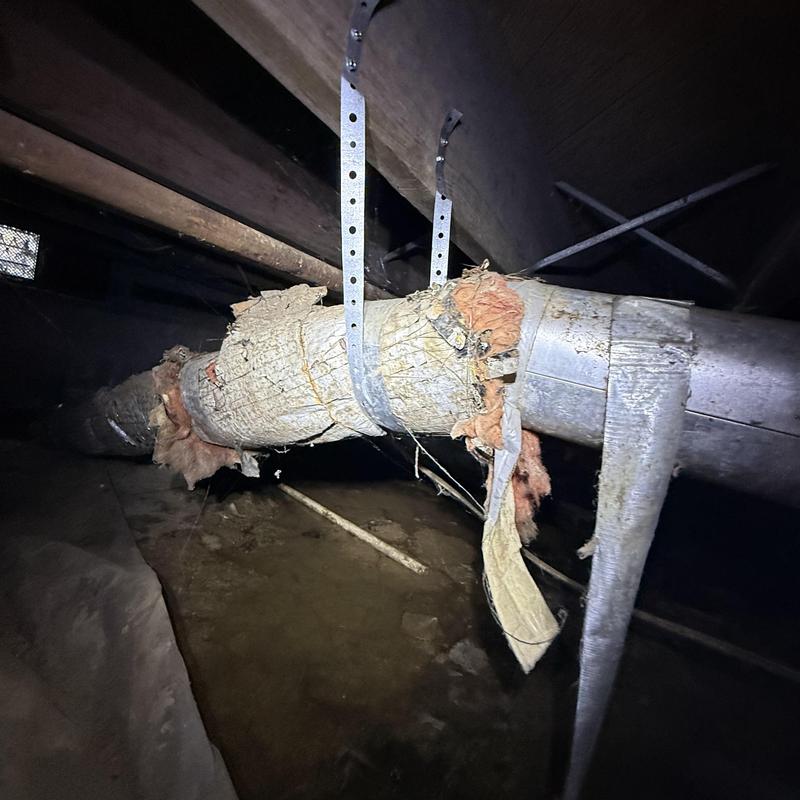 Ductwork with damaged insulation hanging in crawl space Ductwork with damaged insulation hanging in crawl space