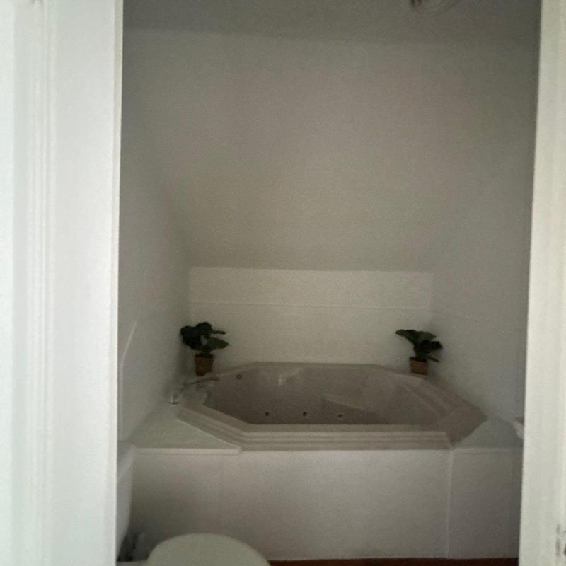 Whirlpool bathtub installation in white bathroom