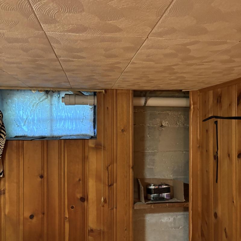 PVC plumbing pipe installation in basement wall cavity