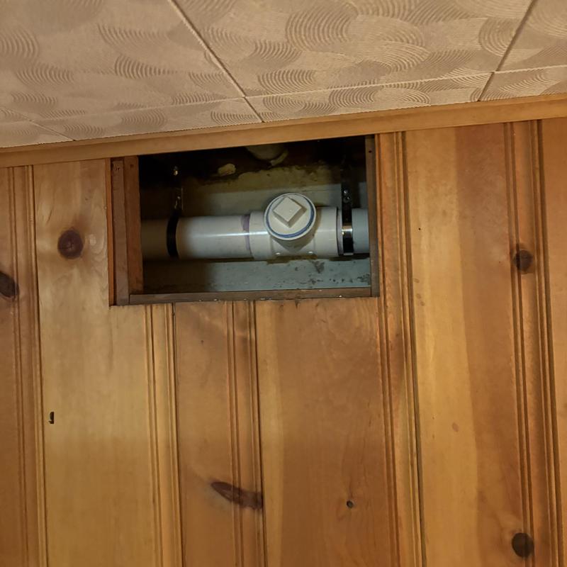 PVC plumbing pipe section with cleanout access panel